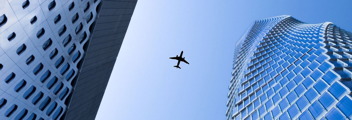 Plane over buildings